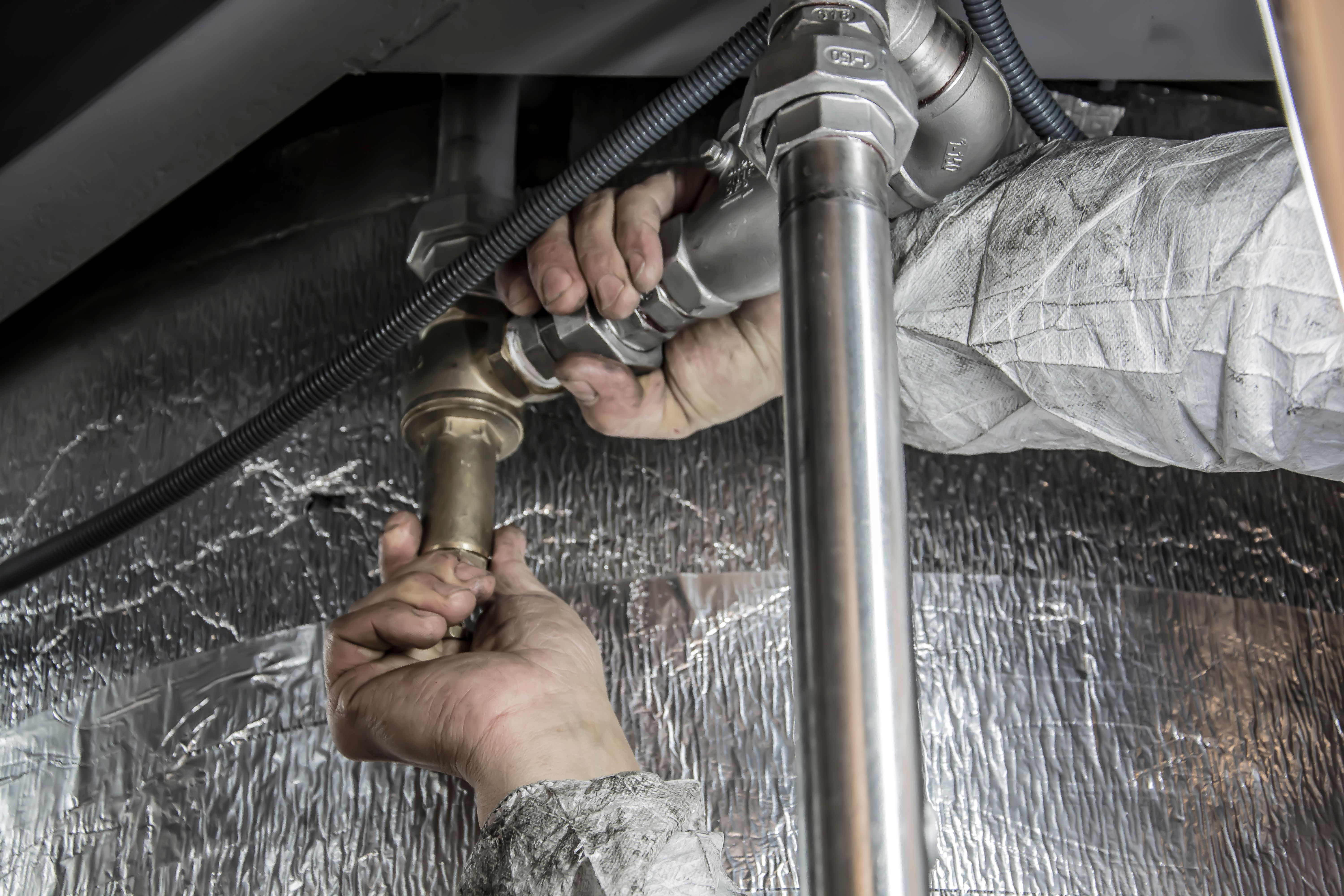 Professional plumbing pipework being connected